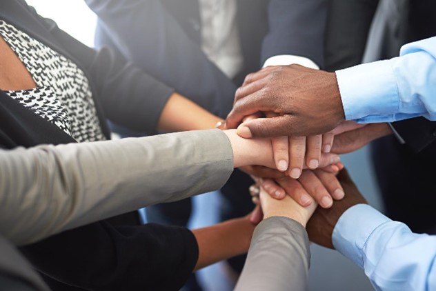 Colleagues joining their hands in unity